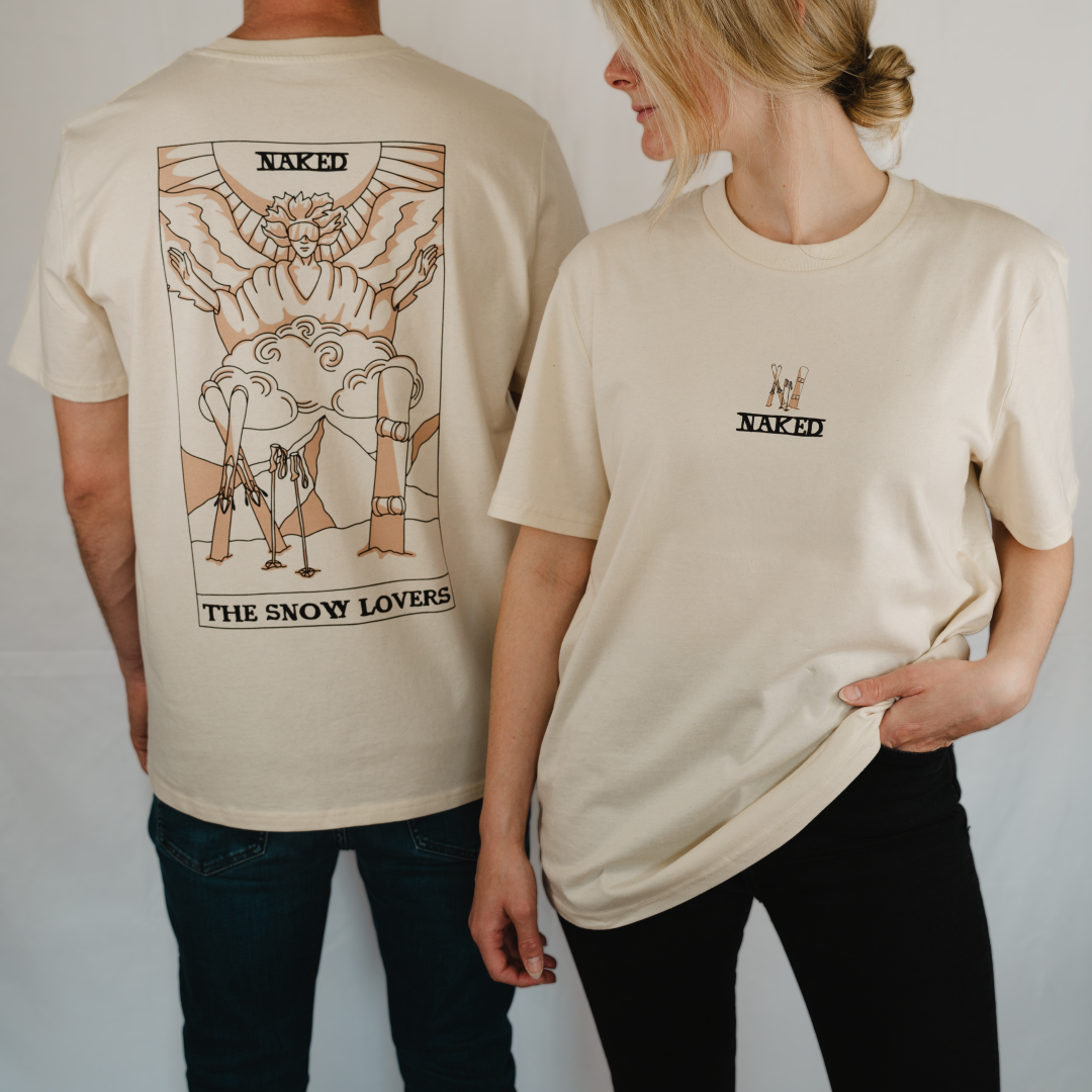 Two people wear the cream T-Shirt Snow-Love by NAKED Optics; one displays a bold backprint design featuring THE SNOW LOVERS, while the other sports a subtle detail on the front. Both shirts are made from soft Bio-Baumwolle for lasting comfort throughout the day.
