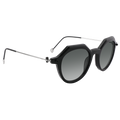The IZZY by NAKED Optics features a black geometric acetate frame with round dark lenses, UV400 protection, and thin silver arms, offering both durability and elegance on a white background.