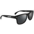 Die SLUSH von NAKED Optics ist eine schwarze Sonnenbrille mit dem weißen Schriftzug „NAKED“ auf den Bügeln und dunkel getönten, polarisierten Gläsern – perfekt für Outdoor-Aktivitäten.
