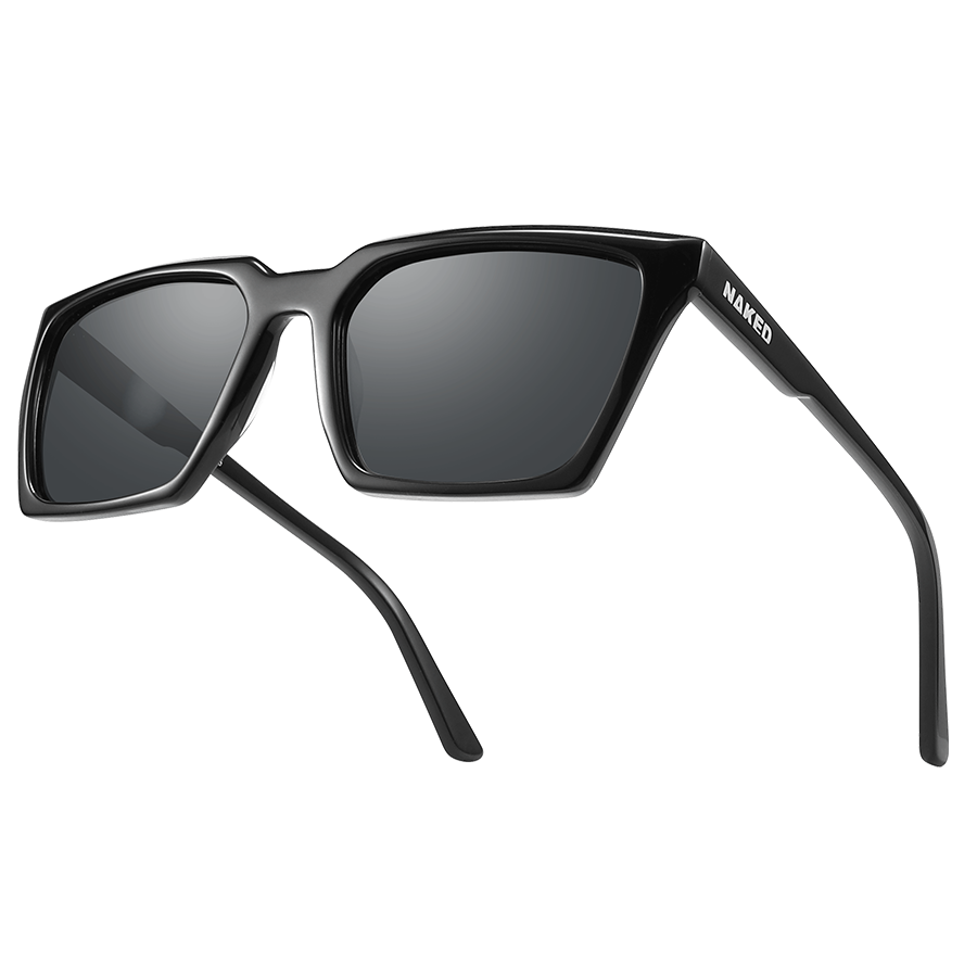 Rectangular black sunglasses with thick frames and dark lenses rest on a light background. The MUSE by NAKED Optics feature UV400 protection and polarized lenses, providing both style and superior eye protection. The brand name NAKED is printed on the arm.