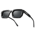 Black rectangular sunglasses called The IRIS by NAKED Optics, featuring thick frames with the brand name on the left arm, equipped with polarized lenses and UV400 protection, set against a white background.