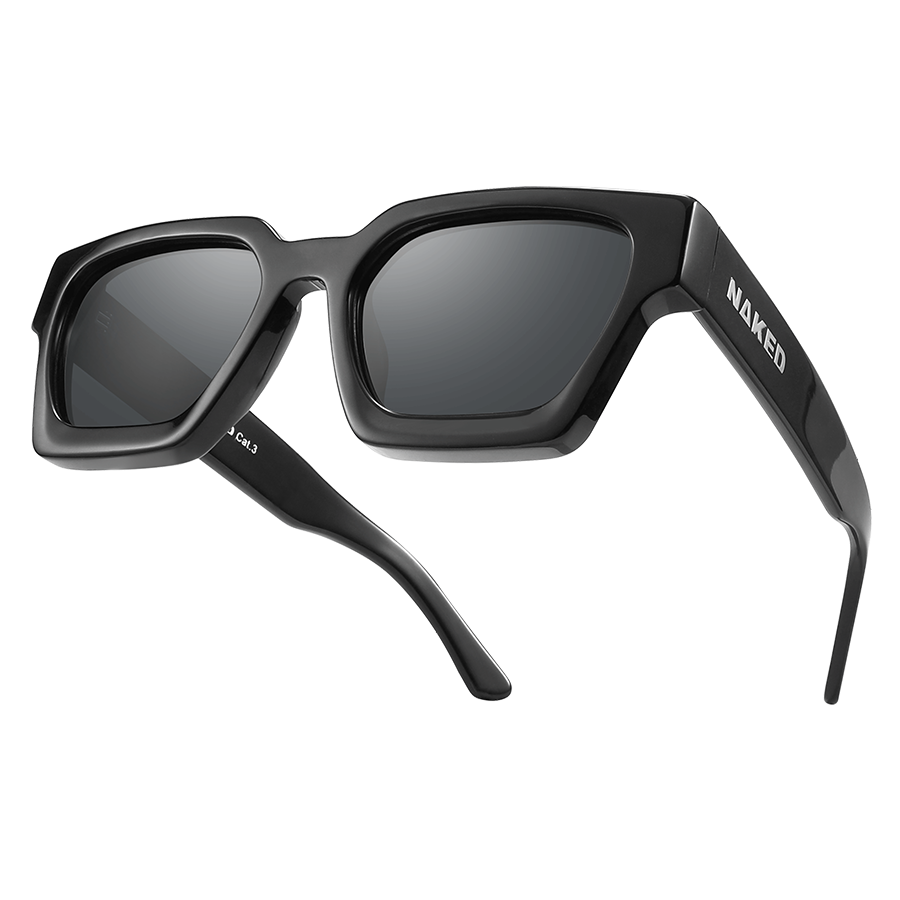The AURA by NAKED Optics is an angular black Sonnenbrille with thick frames and dark polarisierte Gläser, showcasing a bold Retro-Design and the signature NAKED logo on the temple arm.