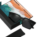 Introducing The MUSE by NAKED Optics: Unisex black sunglasses delivered in a sleek black case, featuring polarisierte Gläser and UV400 Schutz for optimal eye protection. Comes with a beach-themed cleaning cloth and the #lifeisbetternaked slogan—style and safety for everyone.