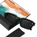 Introducing The IRIS by NAKED Optics: black sunglasses in a case, complete with a beach-themed cloth featuring the #lifeisbetternaked text. Designed with polarized lenses and UV400 protection for ultimate eye safety.