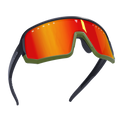 The NAKED Optics VOLT Hero-Edition sunglasses feature red-orange mirrored lenses, a black frame, and green lower trim, shown angled on a white background. Inspired by Stevie Schneider, this Mountainbike Brille combines standout style with high-performance for every ride.