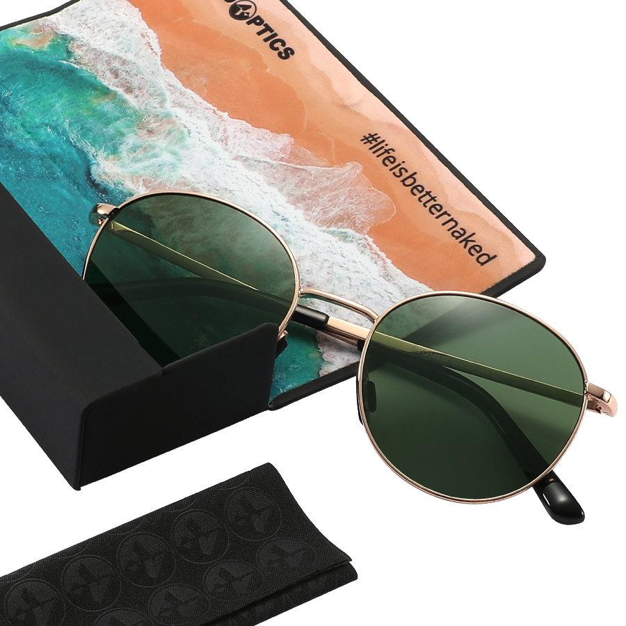 The PARKER round sunglasses by NAKED Optics feature green lenses and a sleek metal frame, elegantly displayed on a case with a beach-themed cloth labeled #lifeisbetternaked. Combining stylish design with practicality, these Metallrahmen Sonnenbrille offer UV400 Schutz—making them the ideal choice for all your sunny adventures.
