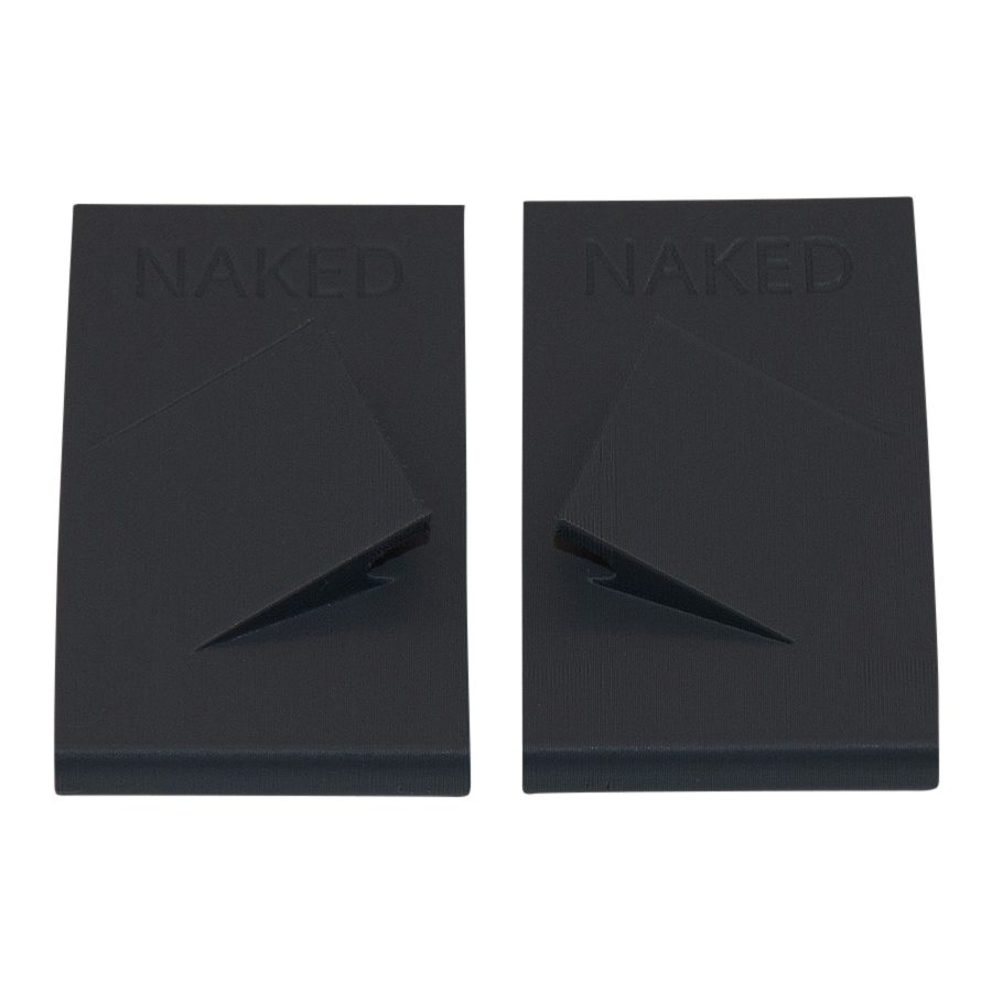Two black rectangular Maskenclip für FFP2 Maske from NAKED Optics, each featuring a raised angular fold in the center, designed for Brillenband Befestigung or use as Maskenclips Skifahren.