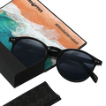 Black sunglasses with dark lenses—such as The WHOOP by NAKED Optics, featuring UV400 protection and polarized lens technology—rest beside a beach-themed card that says #lifesbetternaked.