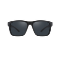 The ASCENT by NAKED Optics: black rectangular sunglasses with dark lenses, shown from the front against a plain white background. Designed as a modern Gletscherbrille, they provide alpine Abenteuer-ready UV400 protection for your eyes.