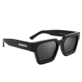 The AURA by NAKED Optics is a black rectangular pair of sunglasses with thick frames and “NAKED” written in white on the left temple, featuring a stylish retro design for a timeless look.