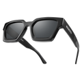 The AURA by NAKED Optics is an angular black Sonnenbrille with thick frames and dark polarisierte Gläser, showcasing a bold Retro-Design and the signature NAKED logo on the temple arm.