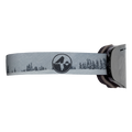 The TROOP Youth by NAKED Optics are gray ski goggles featuring a black-tinted lens, a strap adorned with tree silhouettes and a circular logo. Designed as a kleine Skibrille, they are ideal for Jugendliche and come equipped with an advanced Anti-Fog-Beschichtung to ensure clear vision on the slopes.