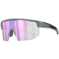 Introducing The SHYFT by NAKED Optics: sport sunglasses with a grey frame and pink reflective lens, featuring signature NAKED branding on the side. Thanks to Passform-Optimierung and 3D-Druck Sportbrille technology, these individually angepasste Sportbrillen deliver a perfect fit for maximum comfort during any activity.