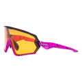 The HAWK by NAKED Optics—pink and black speckled sports sunglasses with large orange-tinted lenses, displayed on a white background—ideal as a Sportbrille klein or Fahrradbrille für kleine Köpfe, ensuring optimal fit and performance.