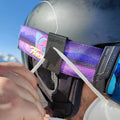 A person wearing a ski helmet, goggles, and an FFP2 mask is adjusting a NAKED Optics Maskenclip für FFP2 Maske strap holder.
